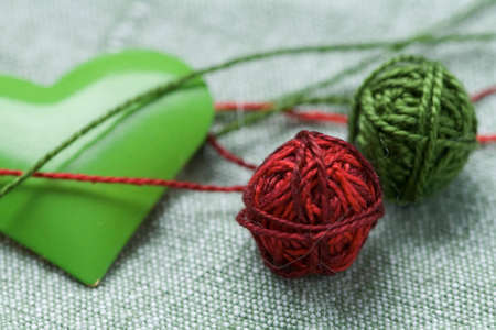 Green iron heart with two clew ballsの写真素材