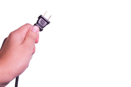 Hand with plug in isolated background.