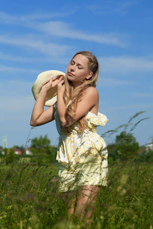 Young attractive woman with white hat enjoy the sunの写真素材