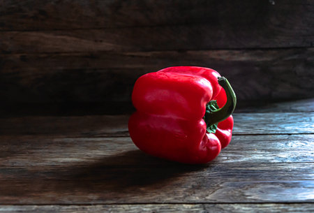 Red bell pepper on a wooden background. Red pepper on a wooden background.の写真素材