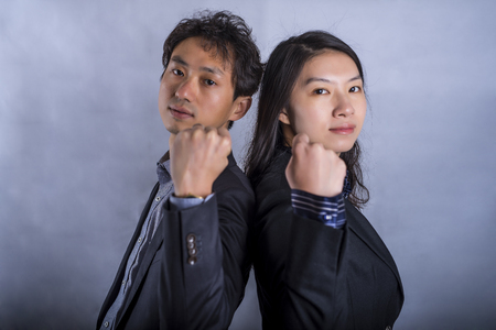 Confident Asian business couple standing next to each otherの写真素材