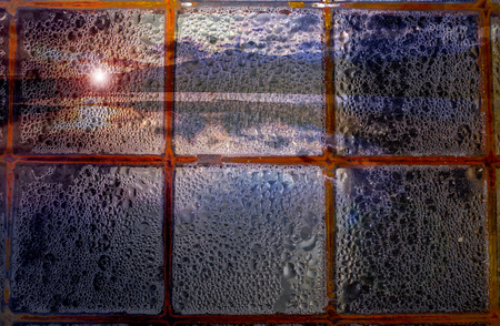 Abstract photography window with rain on a lake sunsetの写真素材