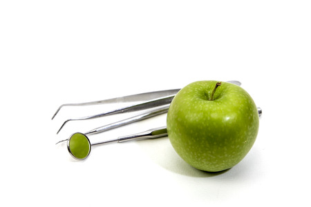 Dental Tools and green appleの写真素材
