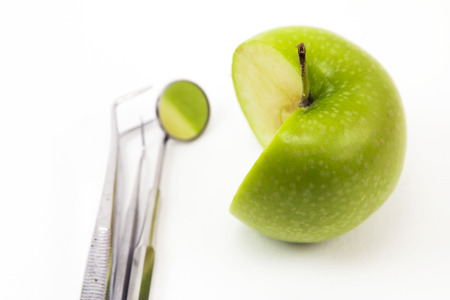 Dental Tools and green appleの写真素材