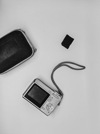 Black and white photo of a camera with pouch