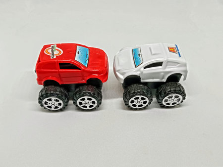 Two miniature toy cars on white background