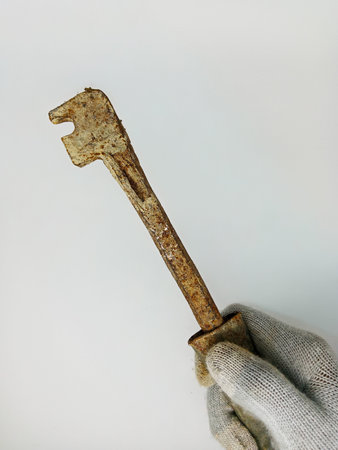 iron bender in the hand of a worker on a white background