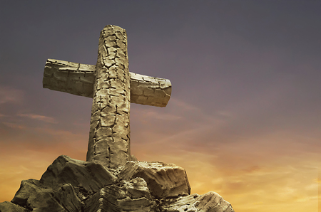 The Holly Statue of a cross against the backdrop of the twilight sky typicallyの写真素材