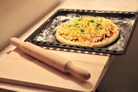 Raw pizza before it will be put in ovenの写真素材