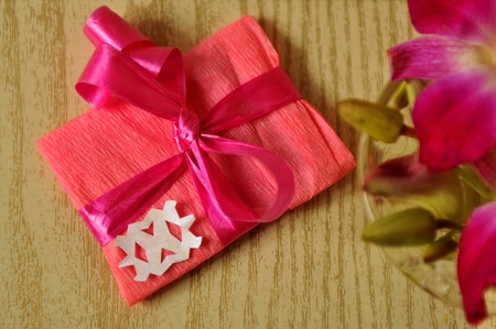 Handmade gift with a big bow and a flowersの写真素材