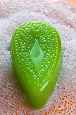 Handmade natural green soap between a bubblesの写真素材
