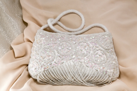 White purse on a silk fabricの写真素材
