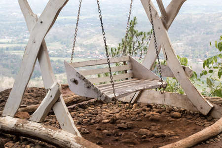 Hanging chairs on the edge of a beautiful cliffの写真素材