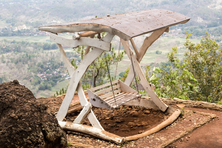 Hanging chairs on the edge of a beautiful cliffの写真素材