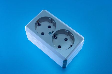 The electric double socket on a blue background
