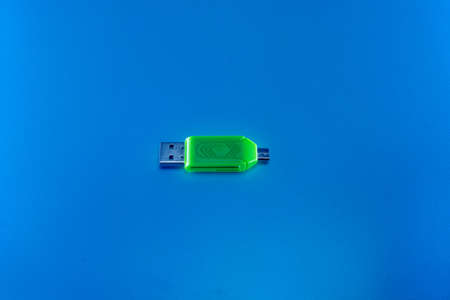 USB OTG converter green on blue backgroundの写真素材