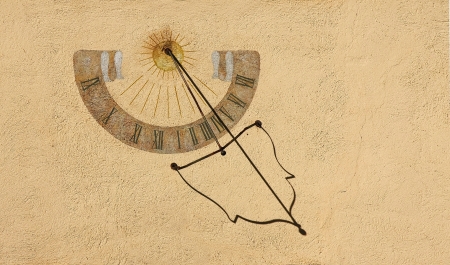 Antique Sundial on an old wallの写真素材