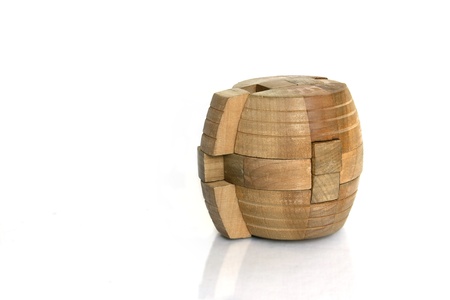 A cylindrical wooden puzzle with part out of the blockの写真素材