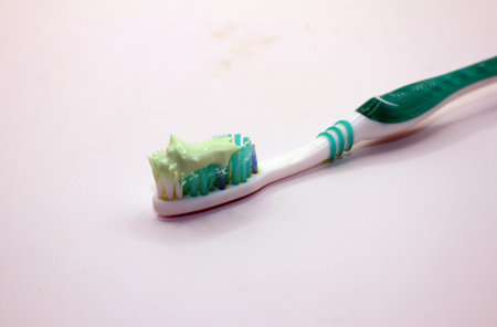 Toothbrush with toothpaste on a white background, close-up