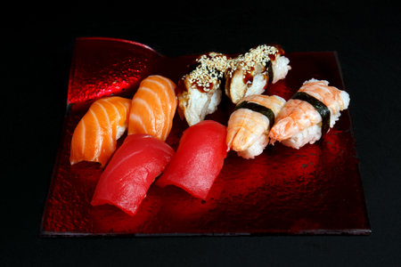 Asian cuisine dish, delicious sushi, sushi on a black background, roll you net on a black background,の写真素材