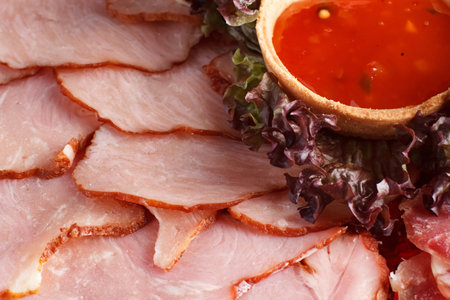 Slices of smoked bacon with lettuce and tomato sauce, closeup