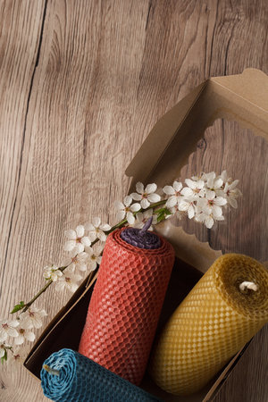 candles made of natural wax, candles of different colors in a box with flowers and candles.の写真素材