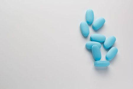 blue tablets on a light background, vitamins and medicines.