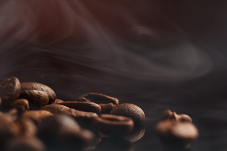 coffee beans on a dark background with a red highlight on the background, coffee beans close-up for a coffee shop.の写真素材