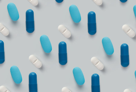 pattern of pills on a blue background. Many pills on a light background.の写真素材