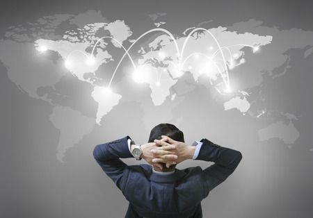 businessman turn and watch the global mapの写真素材