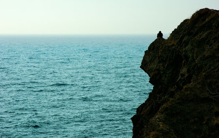 alone on the mountain coast of seaの写真素材
