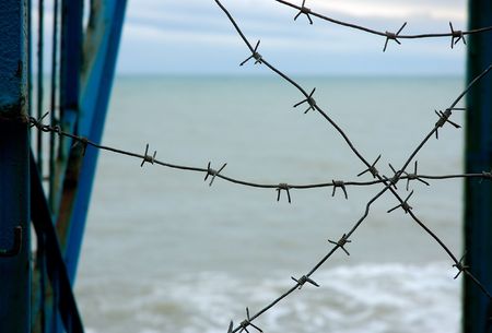 the barbed wire on the sea coastの写真素材