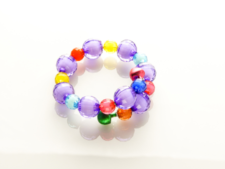 Multi-colored bracelets with beads. Colourful child's bead bracelet.の写真素材