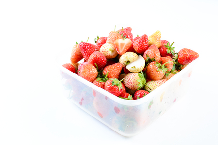 Fresh strawberries in white transparant box on white backgroundの写真素材
