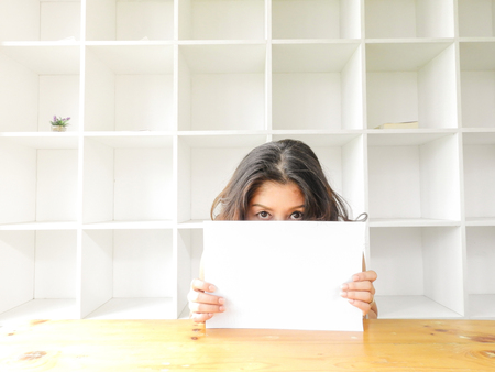 Attractive beautiful woman holding blank white paper.の写真素材