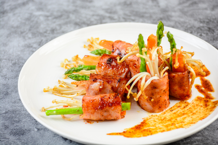 Bacon Wrapped Stuffed Mushrooms, A classic favorite stuffed mushroom is taken to new heights by wrapping in a slice of bacon. Simple, but will melt in your mouthの写真素材