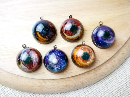 Create galaxy drink coasters using resin, glitter and pigment powders, handmade items. Suitable for keychains, necklace and pendant.の写真素材