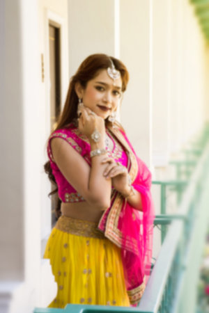 Pink and Yellow Indian Costume Beautiful Girl, face partially covered with saree. Portrait of...