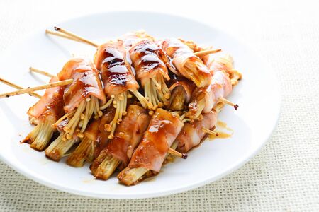 Bacon Wrapped Stuffed Mushrooms, A classic favorite stuffed mushroom is taken to new heights by wrapping in a slice of bacon. Simple, but will melt in your mouthの写真素材