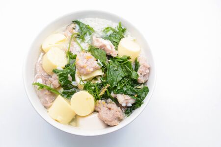 Boiled rice with pork, ivy gourd leaves and soft tofuの写真素材