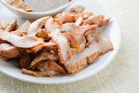 Grilled Pork with Thai Spicy Sauce, it can be served as an appetizer; it can also be served as an entrÃ©e with hot-off-the-splatter-guard sticky rice or plain steamed jasmine rice.の写真素材