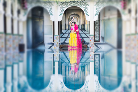 Pink and Yellow Indian Costume Beautiful Girl, face partially covered with saree. Portrait of...