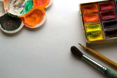 Drawing supplies on white paper. Pencil, paints, brush, palette on paper.の写真素材