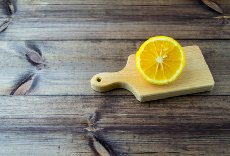 Lemon on a dark wooden table. Lemon cut on a dark wooden table close-up.の写真素材