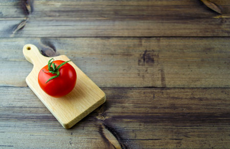 Tomato on a dark wooden table. Tomato on a dark wooden table close-up.の写真素材