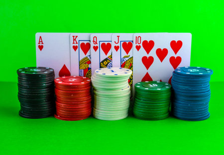 Poker chips in stacks and royal flush on the table. Cards on the table with a combination of royal...