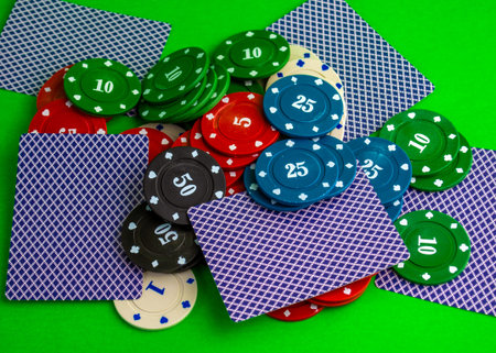 Poker game, cards and chips are scattered on the table. Cards and chips are scattered on the poker...