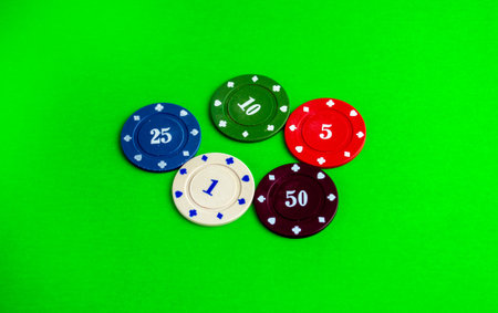 Poker, five chips. Chips on a green poker table.