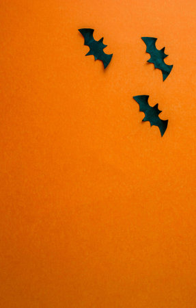 Halloween background, paper black bats on orange background, vertical background. background for advertising.の写真素材