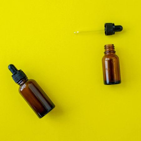 Bottles for cosmetics on a yellow background. beauty saloon. background with copy space. background for advertising.の写真素材